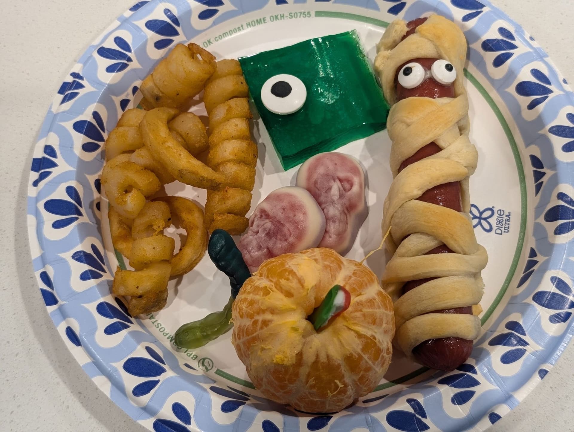 Halloween Mummy Dogs with Crescent Roll Wraps and Candy Eyes